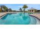 Large community pool with clear blue water and nearby pool house at 981 Fiesta Key Cir, Lady Lake, FL 32159