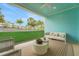 This covered patio has an outdoor seating area overlooking the backyard with a landscaped lawn at 981 Fiesta Key Cir, Lady Lake, FL 32159