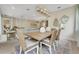 Charming dining room featuring a farmhouse table, stylish lighting, and decorative mirrors at 981 Fiesta Key Cir, Lady Lake, FL 32159