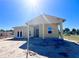 New single-story home under construction featuring a covered porch with classic columns and a bright, airy design at 981 Fiesta Key Cir, Lady Lake, FL 32159