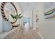 Elegant hallway featuring wood-look tile flooring and decorative accents that create a welcoming ambiance at 981 Fiesta Key Cir, Lady Lake, FL 32159