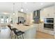 Bright kitchen featuring white cabinets, stainless steel appliances, a central island, and an open layout at 981 Fiesta Key Cir, Lady Lake, FL 32159