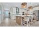 Beautiful kitchen with white cabinetry, stainless steel appliances, large center island, and bar stool seating at 981 Fiesta Key Cir, Lady Lake, FL 32159