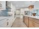 Well-appointed kitchen with white cabinets, subway tile backsplash, and a spacious center island at 981 Fiesta Key Cir, Lady Lake, FL 32159