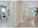 Hallway leading to laundry room with a view of washer and dryer in a modern setting at 981 Fiesta Key Cir, Lady Lake, FL 32159