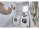 Laundry room features modern appliances and decor, offering a stylish and functional space at 981 Fiesta Key Cir, Lady Lake, FL 32159