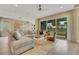 Inviting living room with comfortable seating, stylish decor, and sliding doors to the outdoor space at 981 Fiesta Key Cir, Lady Lake, FL 32159
