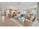 Open-concept living area with stylish furniture, neutral tones, and seamless flow to the kitchen at 981 Fiesta Key Cir, Lady Lake, FL 32159