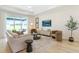 Cozy living room with modern furnishings, a sliding glass door to the patio, and natural light at 981 Fiesta Key Cir, Lady Lake, FL 32159