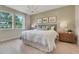 Bright main bedroom featuring a shiplap wall, large windows, and a calming ambiance at 981 Fiesta Key Cir, Lady Lake, FL 32159