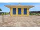 Community pool house exterior showing well maintained brick work and colorful accents at 981 Fiesta Key Cir, Lady Lake, FL 32159