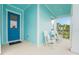 Relaxing porch with rocking chairs and a stylish blue door, perfect for enjoying quiet moments at 981 Fiesta Key Cir, Lady Lake, FL 32159