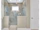 Modern bathroom featuring a tiled walk-in shower with glass door and a neutral color palette at 981 Fiesta Key Cir, Lady Lake, FL 32159
