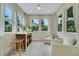 A sunroom offers natural light and comfortable seating, overlooking the outdoor views at 981 Fiesta Key Cir, Lady Lake, FL 32159