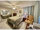 Cozy bedroom with ample storage, mirrored closet, and a comfortable chair for relaxation at 101 Royal Palm Dr, Leesburg, FL 34748