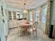 Charming dining area with a round table, surrounded by natural light from the windows at 101 Royal Palm Dr, Leesburg, FL 34748