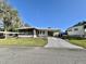 Charming single-story home with well-maintained lawn and convenient carport at 101 Royal Palm Dr, Leesburg, FL 34748