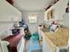 Bright laundry room with washer, dryer, sink, and ample cabinet storage space at 101 Royal Palm Dr, Leesburg, FL 34748