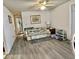 Bright living room featuring a ceiling fan and hard surface flooring at 101 Royal Palm Dr, Leesburg, FL 34748