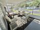 Relaxing screened porch with comfortable seating, ideal for enjoying the outdoors at 101 Royal Palm Dr, Leesburg, FL 34748