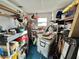 Cluttered storage room with shelving, tools, and ample space for organizing belongings at 101 Royal Palm Dr, Leesburg, FL 34748