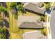 An aerial view showing the layout of the property, including the fenced backyard and proximity to other houses at 1023 Timbervale Trl, Clermont, FL 34715