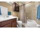 Well-lit bathroom with a shower-tub combo and wood-grain vanity at 1023 Timbervale Trl, Clermont, FL 34715