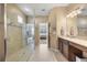 Luxurious bathroom with a glass shower, granite countertop, and neutral tones at 1023 Timbervale Trl, Clermont, FL 34715