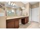 Elegant bathroom with dual sinks, a granite countertop, and a glass shower at 1023 Timbervale Trl, Clermont, FL 34715