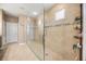 Elegant bathroom featuring a glass-enclosed shower and neutral tiling at 1023 Timbervale Trl, Clermont, FL 34715