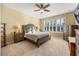 Comfortable bedroom with a ceiling fan, plenty of light, and classic furniture at 1023 Timbervale Trl, Clermont, FL 34715
