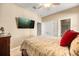 Comfortable bedroom featuring a ceiling fan, TV, and ensuite bathroom at 1023 Timbervale Trl, Clermont, FL 34715