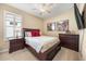 Cozy bedroom with a ceiling fan, large window, and a chest of drawers at 1023 Timbervale Trl, Clermont, FL 34715