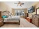 Inviting bedroom features a ceiling fan, shuttered windows, and coordinated furniture at 1023 Timbervale Trl, Clermont, FL 34715