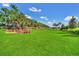 Expansive dog park with lush green grass and mature trees, providing a secure and enjoyable space for pets at 1023 Timbervale Trl, Clermont, FL 34715