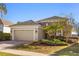 Charming single-story home with manicured lawn, beautiful stone details, and a convenient two-car garage at 1023 Timbervale Trl, Clermont, FL 34715