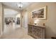 Inviting hallway with tile flooring, arched doorways, and a decorative console table at 1023 Timbervale Trl, Clermont, FL 34715