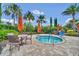 Relaxing hot tub surrounded by tropical landscaping, tables, and chairs for an inviting outdoor oasis at 1023 Timbervale Trl, Clermont, FL 34715