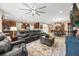 Open-concept living room flowing into the kitchen and dining area with comfortable seating at 1023 Timbervale Trl, Clermont, FL 34715