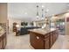 Open-concept living space featuring a kitchen island with seating and a comfortable living area at 1023 Timbervale Trl, Clermont, FL 34715