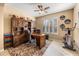Bright office featuring built-in shelving, plantation shutters, and an exercise bike at 1023 Timbervale Trl, Clermont, FL 34715