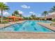 Long, inviting swimming pool perfect for laps with bright blue water, clear lane markers and covered lounge area at 1023 Timbervale Trl, Clermont, FL 34715