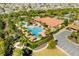 Aerial view of the resort-style community pool area with cabanas, lounge chairs, and tropical landscaping at 1023 Timbervale Trl, Clermont, FL 34715