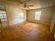 Bedroom with ceiling fan and wood walls at 103 Caroline Ave, Lady Lake, FL 32159