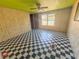 Bed room featuring black and white checkered flooring and wood paneled walls at 103 Caroline Ave, Lady Lake, FL 32159