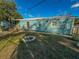 Side view of the house with small stone firepit at 103 Caroline Ave, Lady Lake, FL 32159
