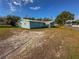 View of the garage and backyard with chainlink fence at 103 Caroline Ave, Lady Lake, FL 32159