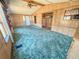 Spacious living room with wood paneled walls and blue carpet at 103 Caroline Ave, Lady Lake, FL 32159