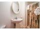 Bathroom with modern sink, round mirror, and shower with patterned curtain at 10301 Us Highway 27 # 84, Clermont, FL 34711