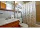 Bathroom featuring white tile, a wooden vanity, and a decorative shower curtain at 10301 Us Highway 27 # 84, Clermont, FL 34711